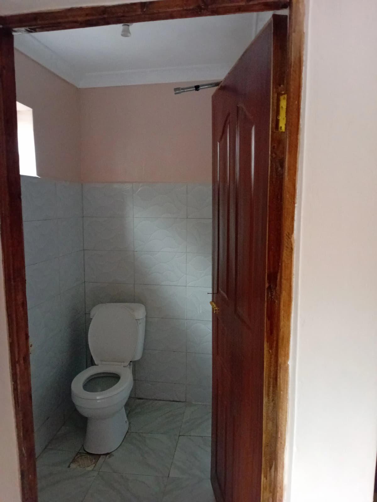 Simple bathroom with toilet and blue tile walls