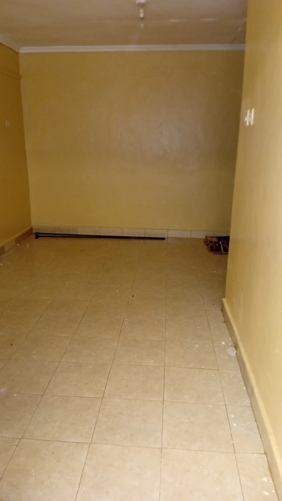 Unfurnished bedroom with pale yellow walls, ceramic tile flooring