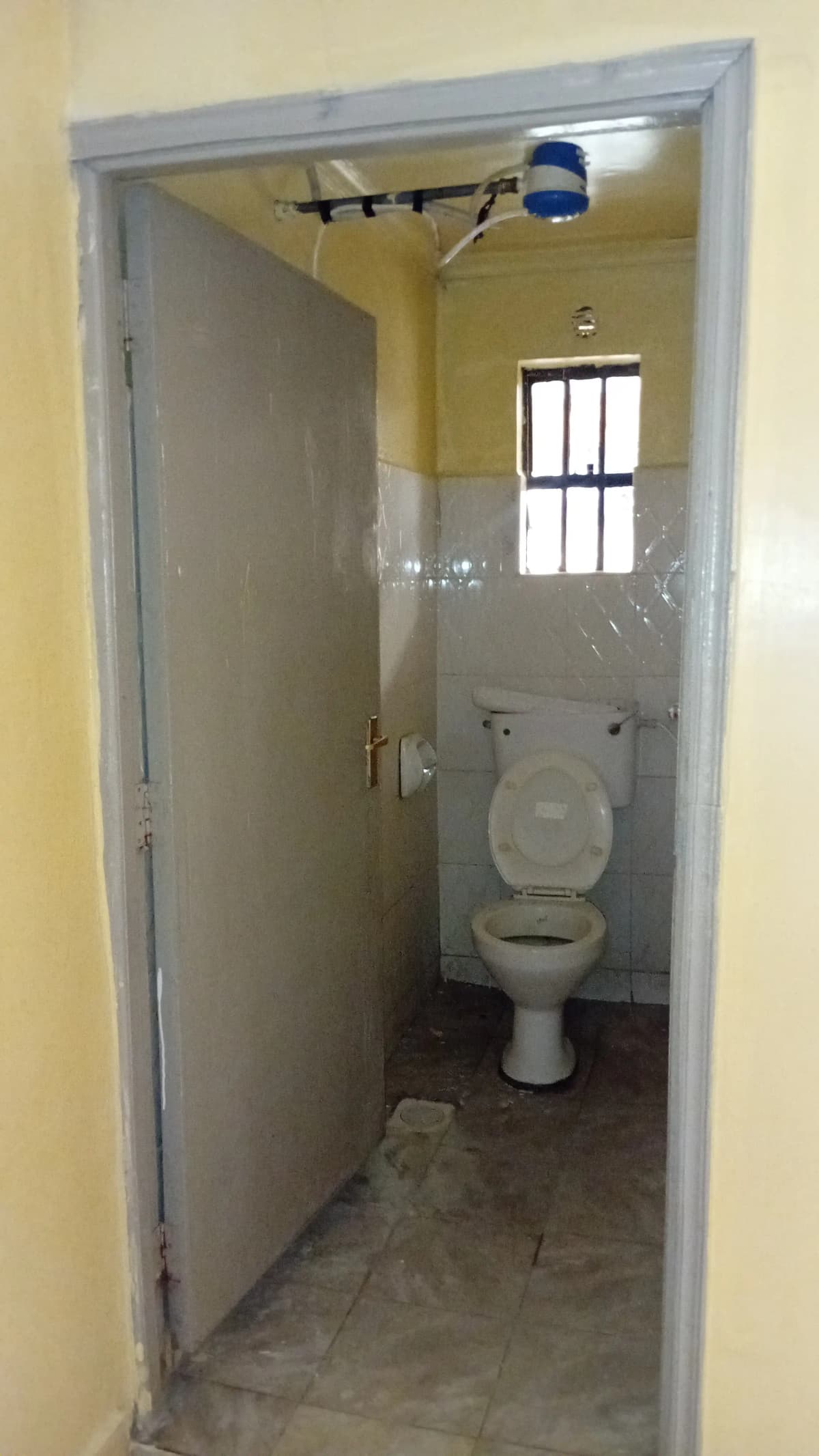 Small bathroom with toilet and natural light from window