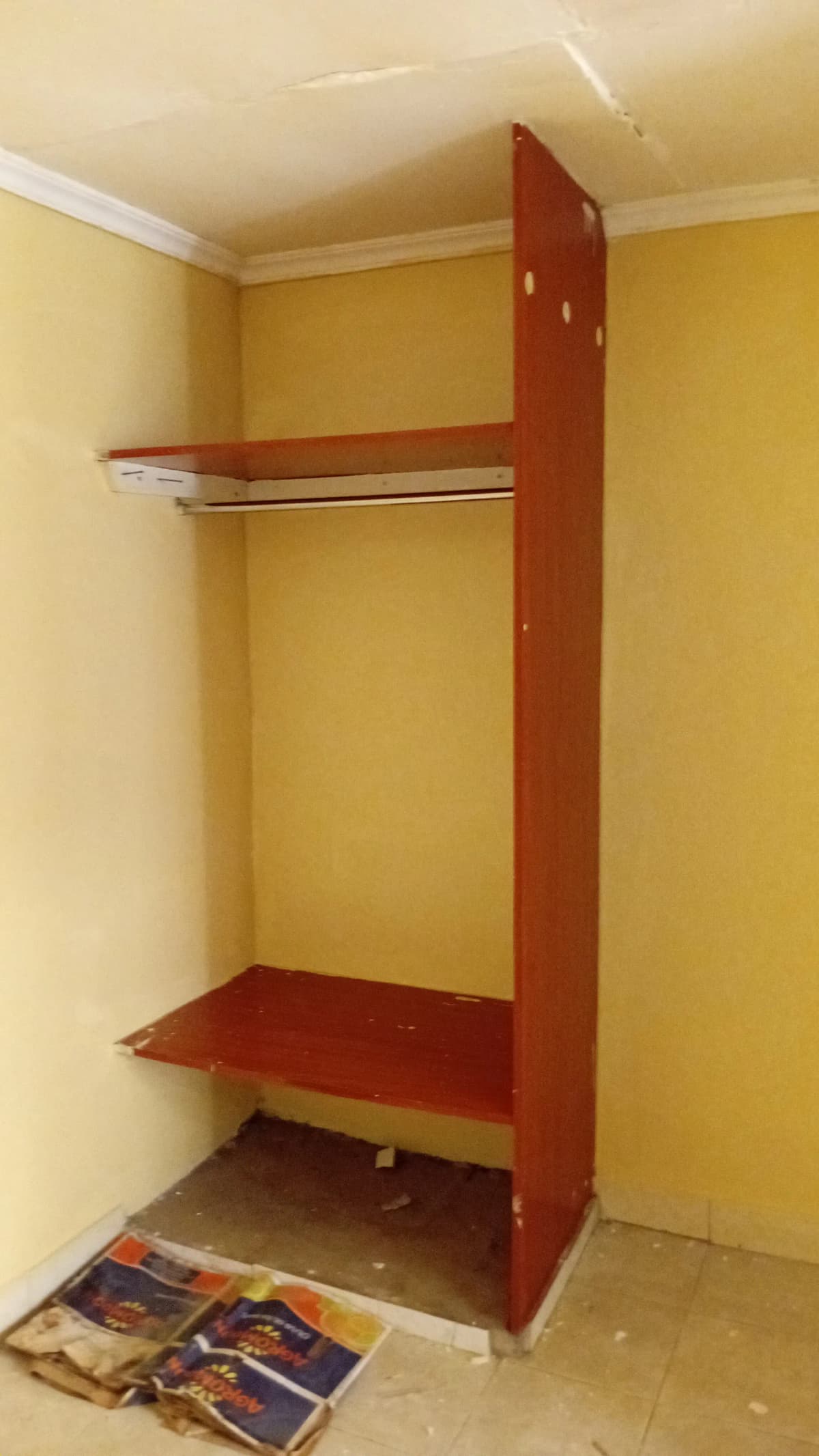 Red wooden wardrobe structure under construction or assembly
