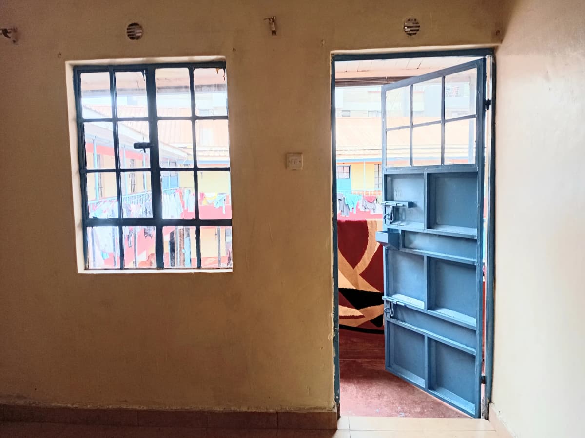 Corridor with windows and blue door to adjacent room
