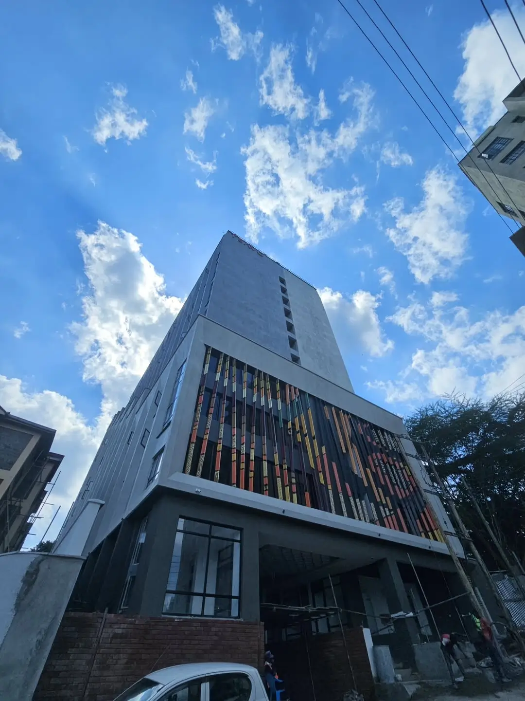 Modern multi-story residential building facade with ground-level commercial space