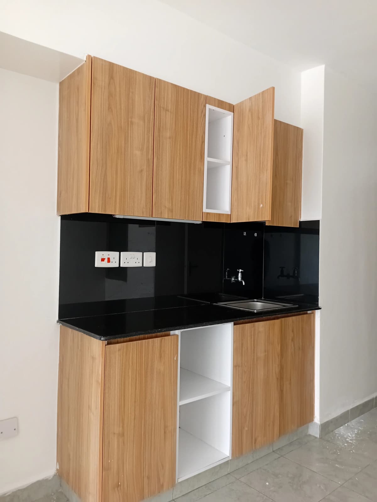 Modern kitchen with wooden cabinets and black countertop