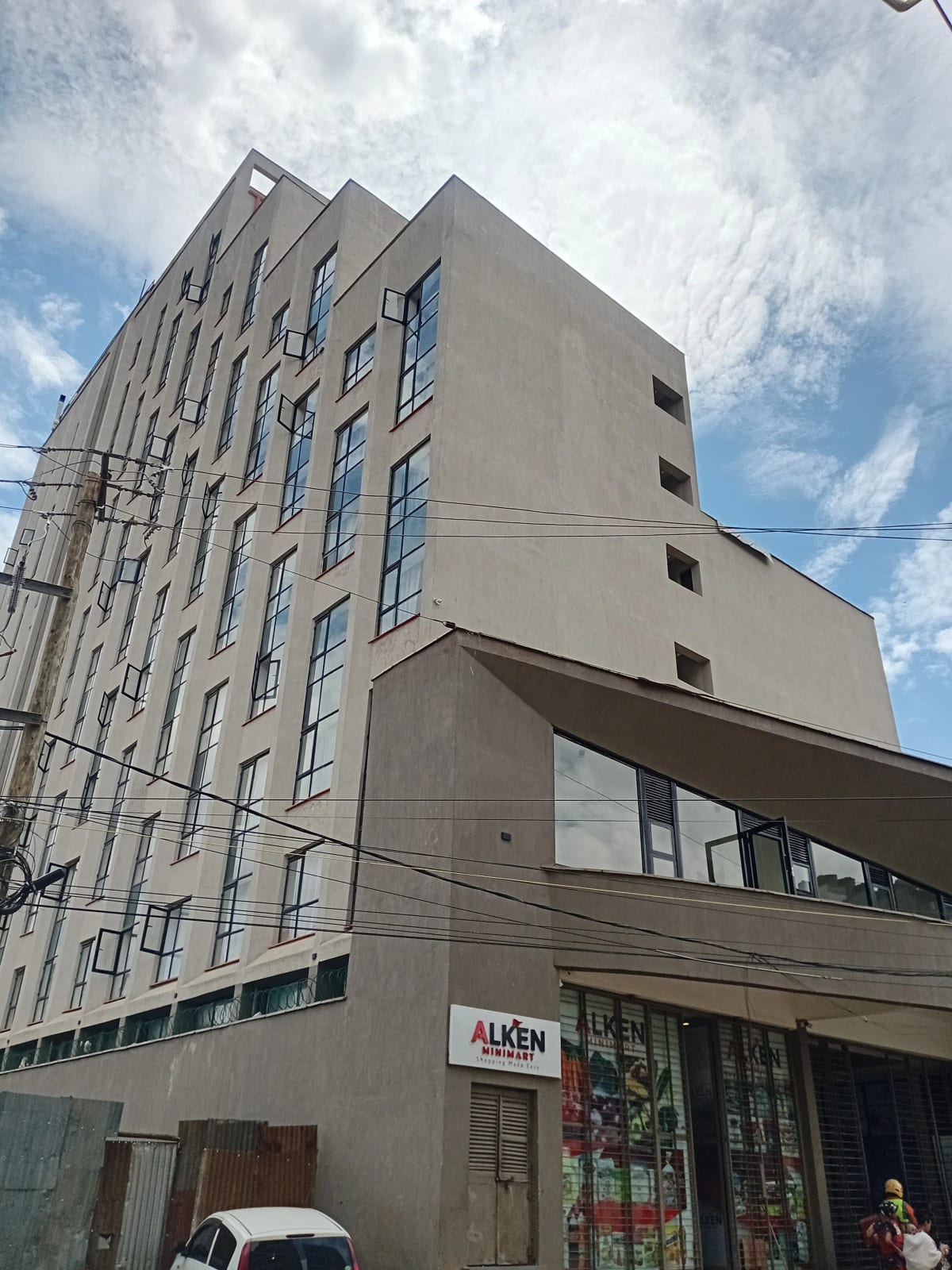 Modern multi-story residential building facade with ground-floor retail