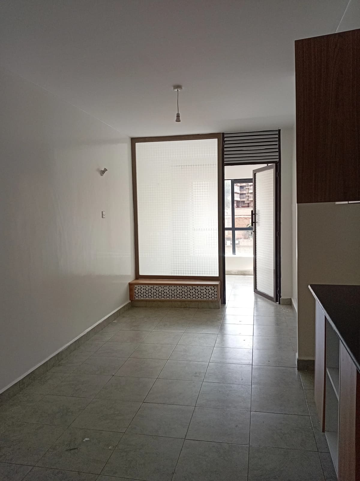 Bright corridor with tiled flooring and interior doorways