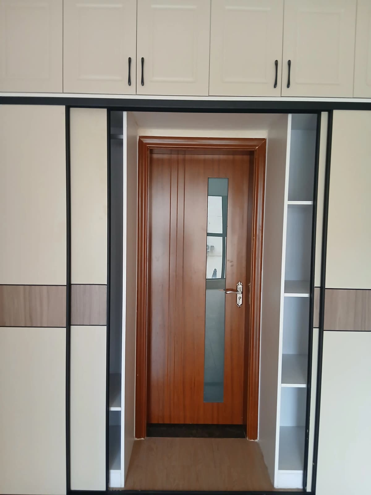 Modern lobby entrance with wooden door and built-in storage