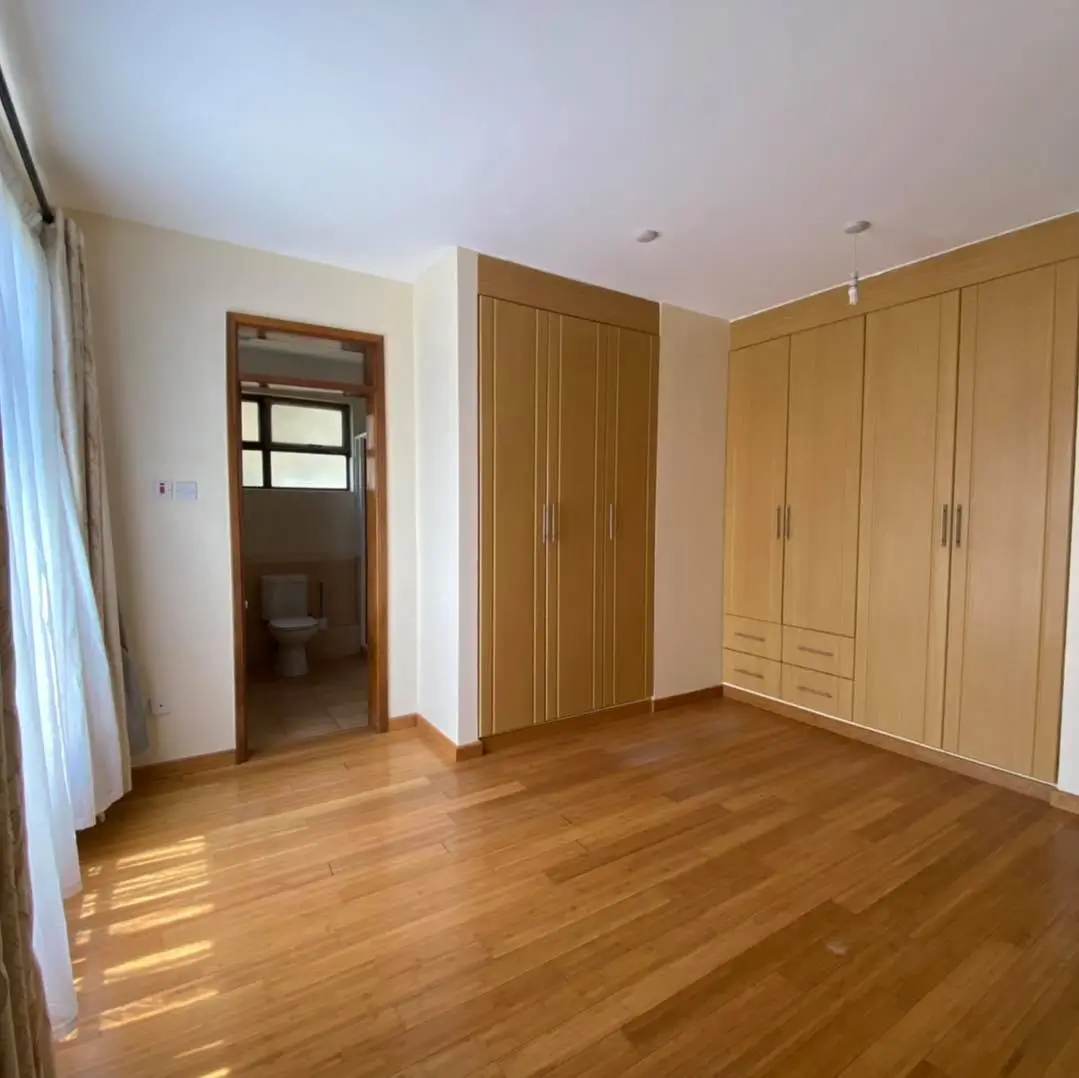 Spacious bedroom with wooden wardrobe and en-suite access