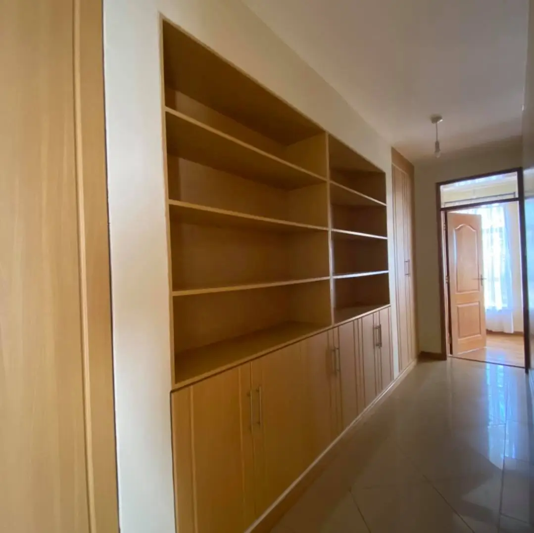 Modern hallway with built-in wooden shelving and storage