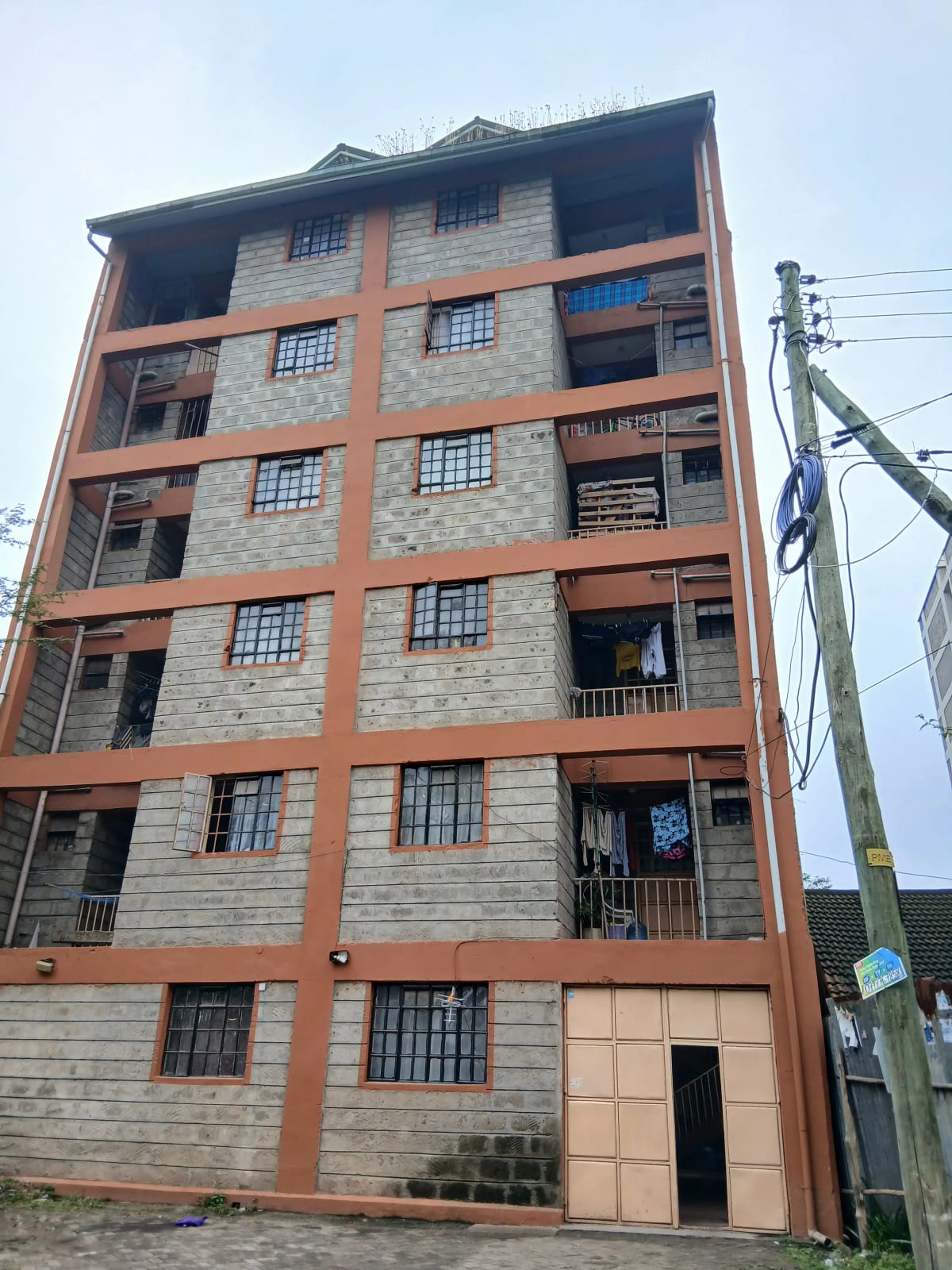 Six-story residential building with brick and stone facade
