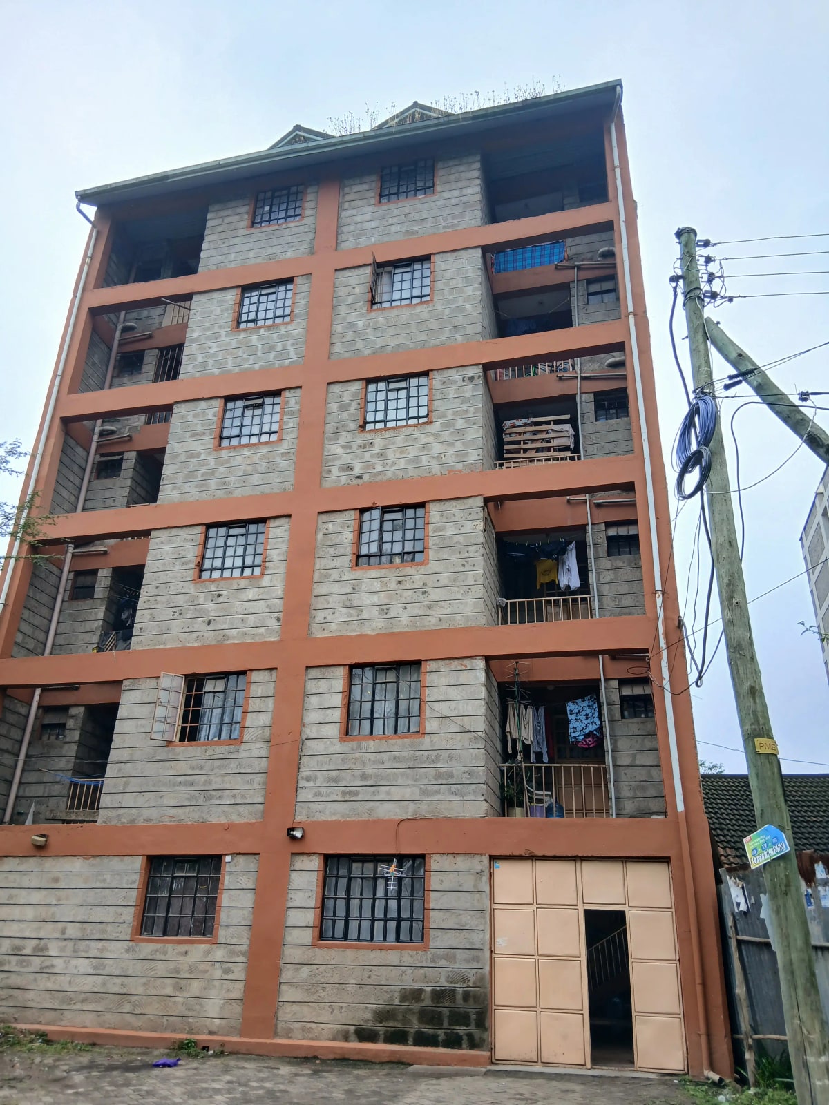 Six-story residential building with brick and stone facade