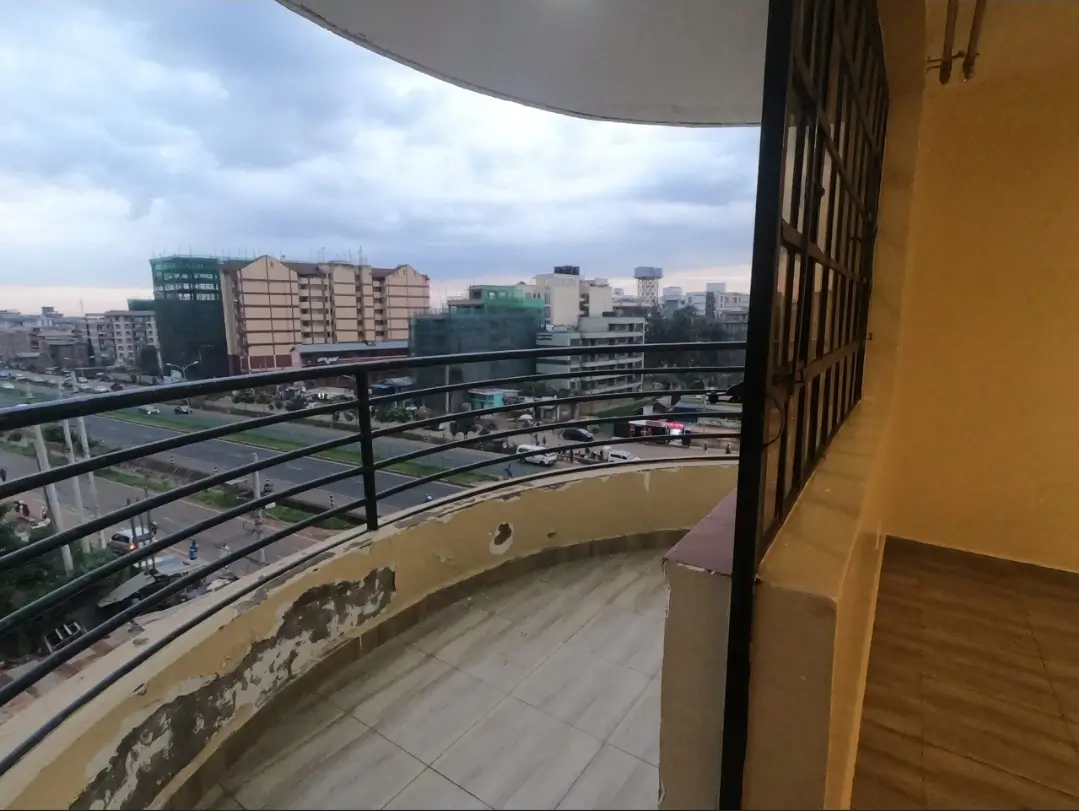 Curved balcony with panoramic city skyline and highway views