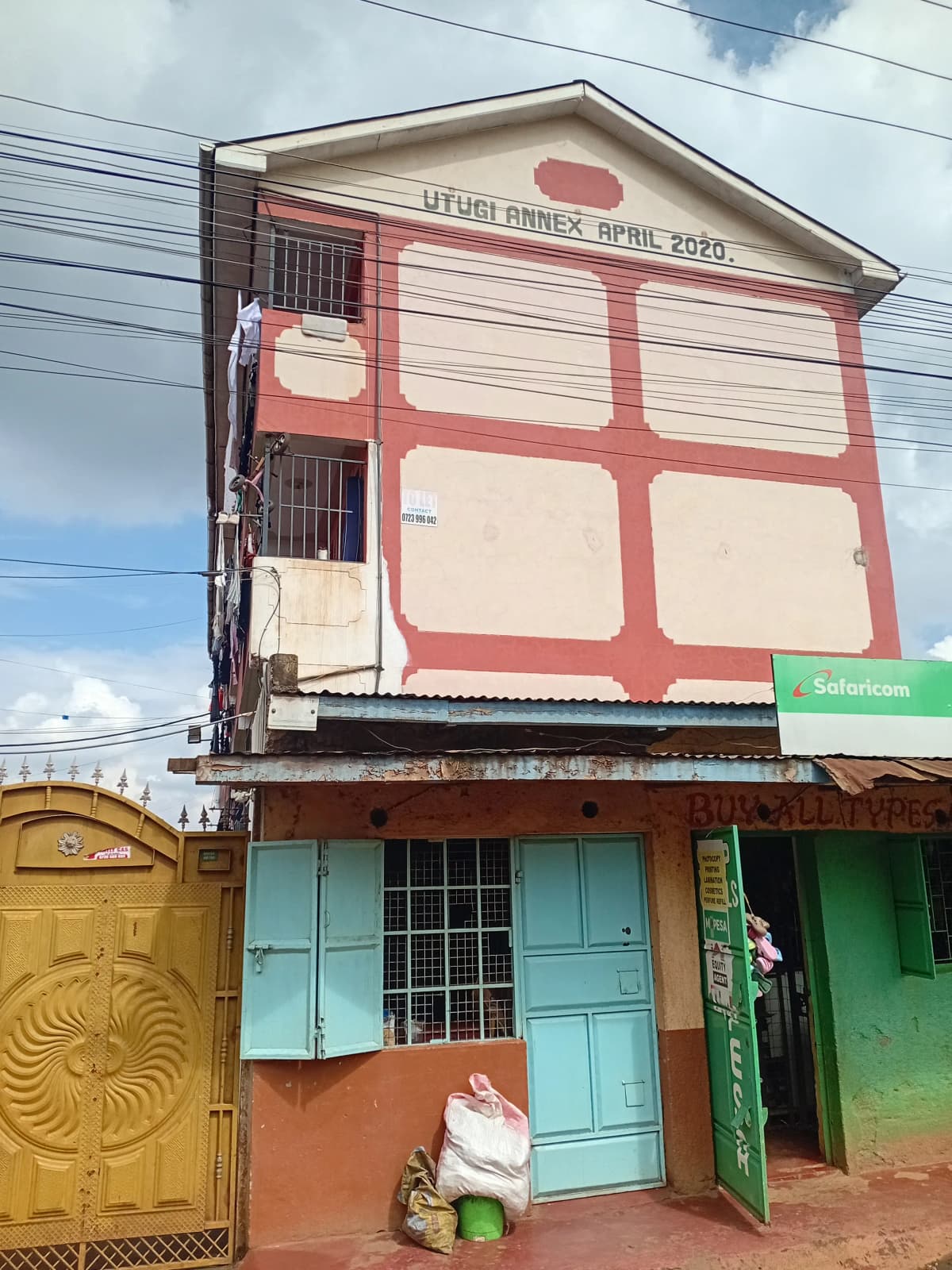 Multi-story residential building facade with red trim detailing