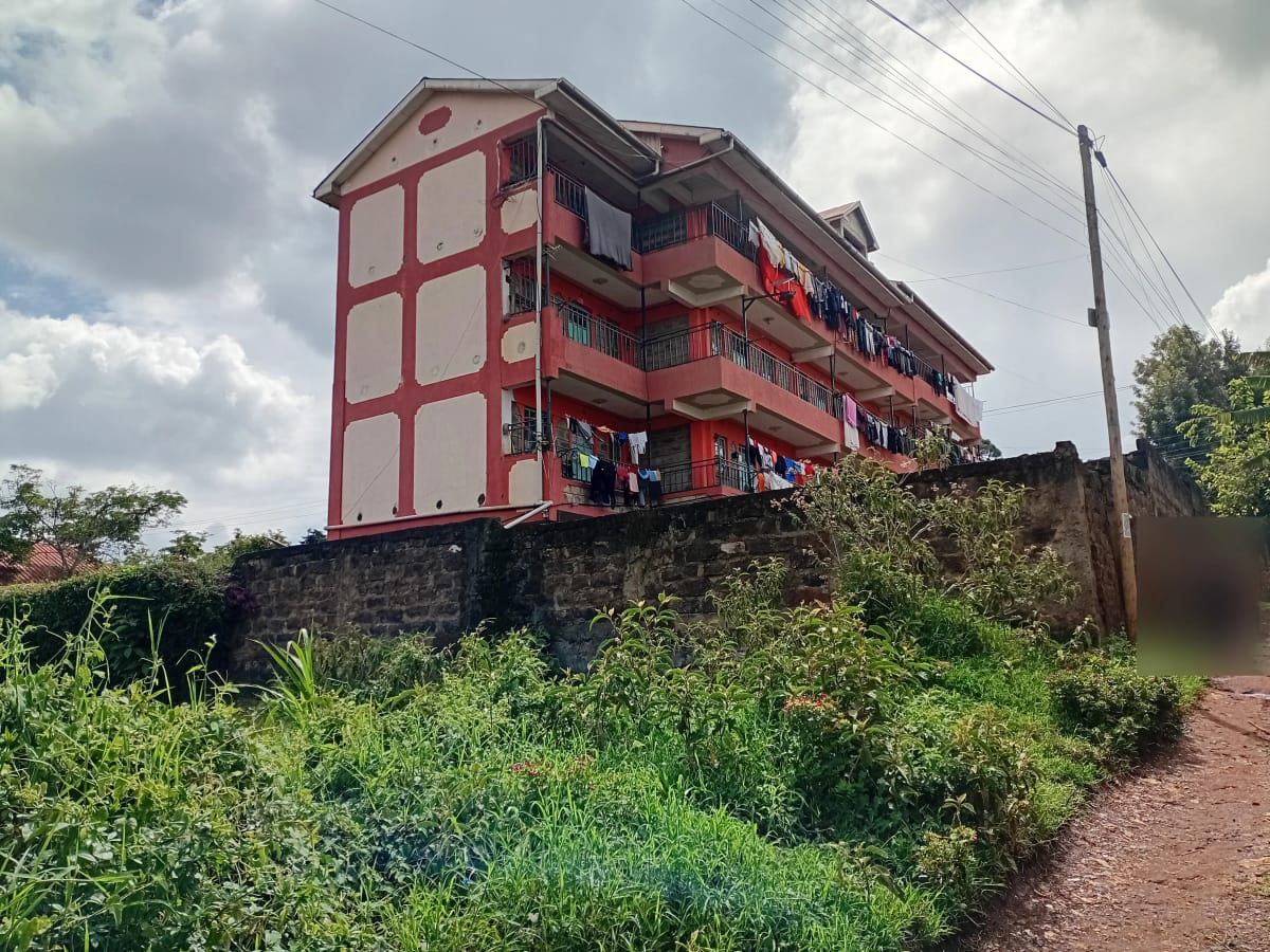 Red and cream multi-story residential building with balconies