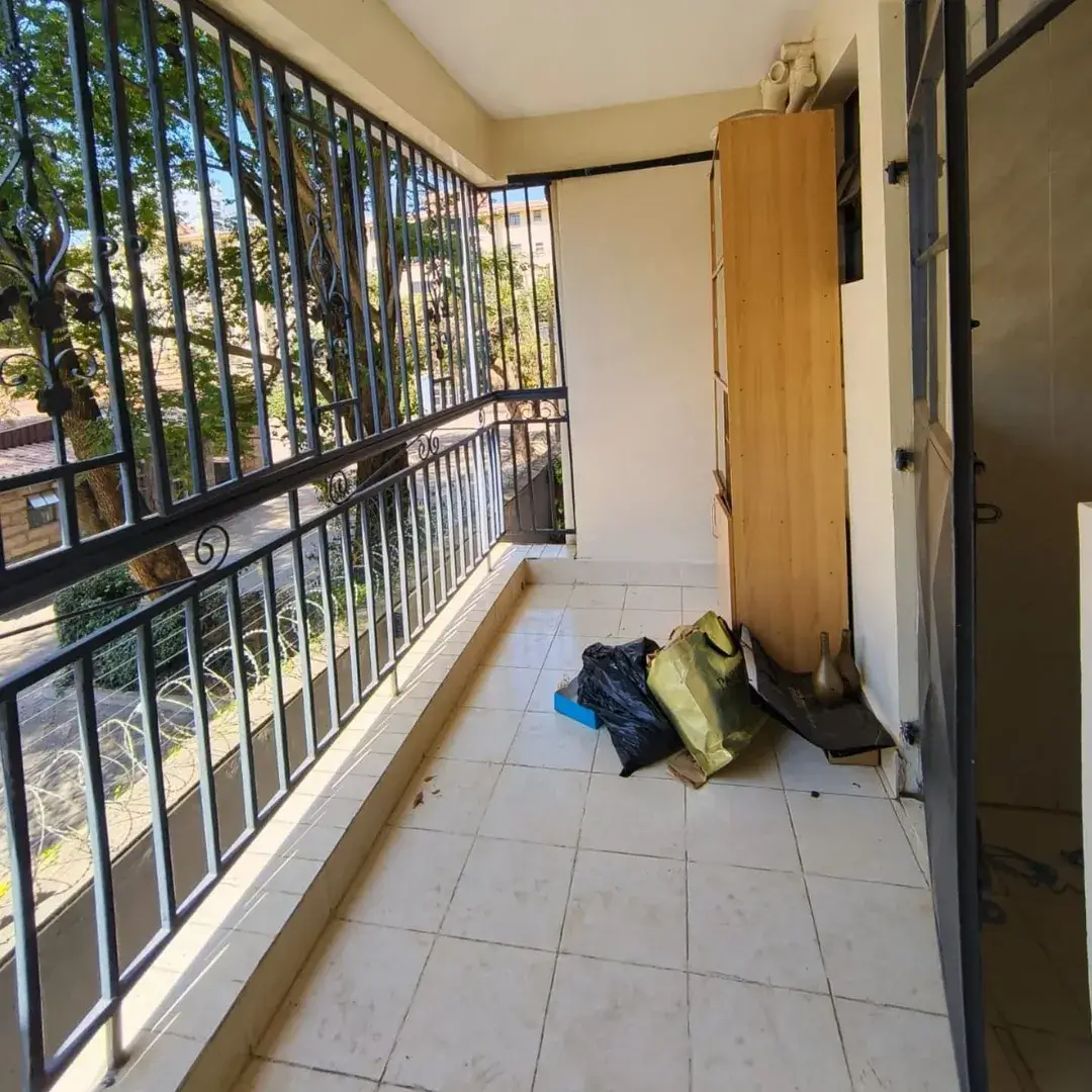 Narrow balcony with metal railings and garden views