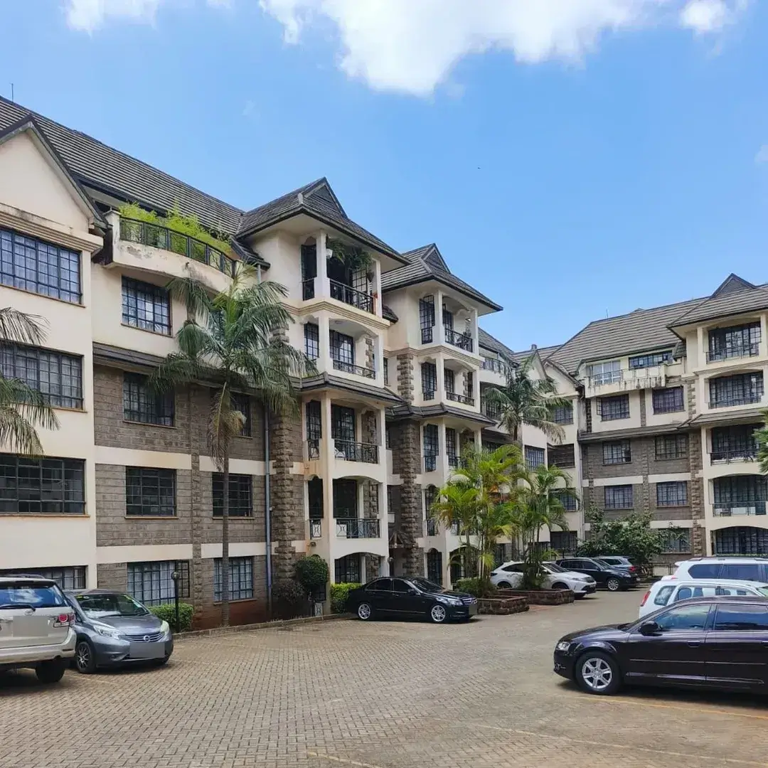 Multi-story residential complex with paved parking compound