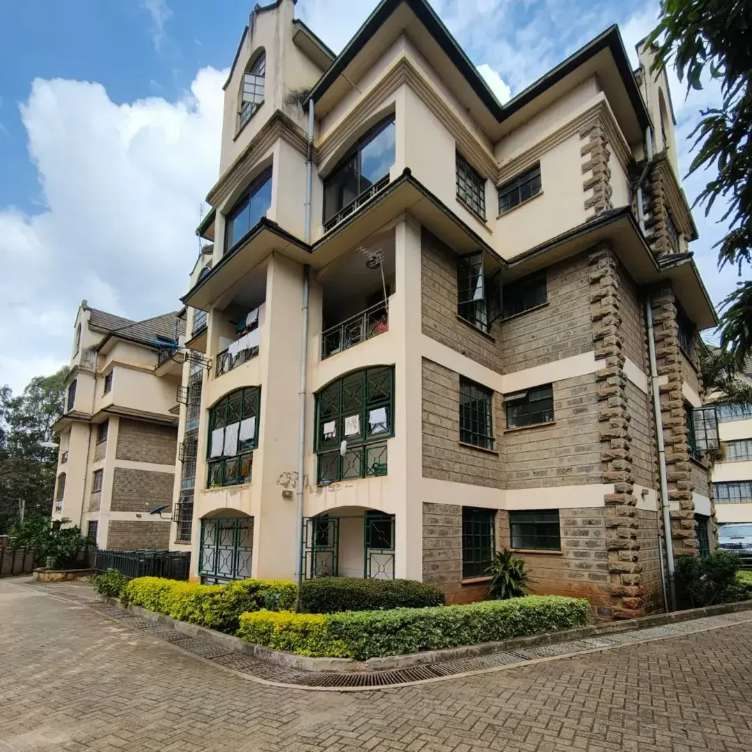 Multi-story residential building with cream and stone facade