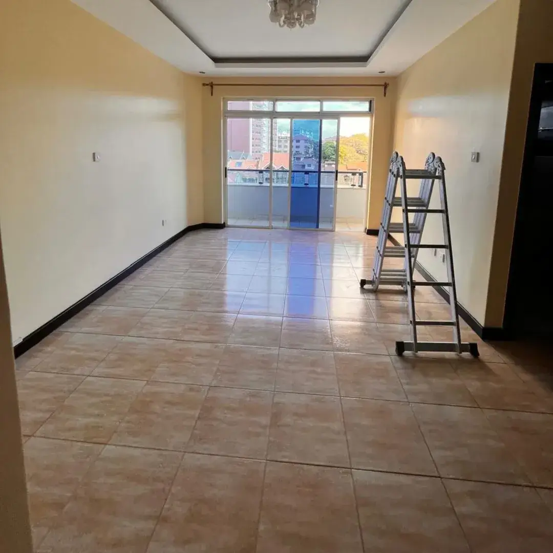 Spacious bedroom with tiled flooring and glass doors