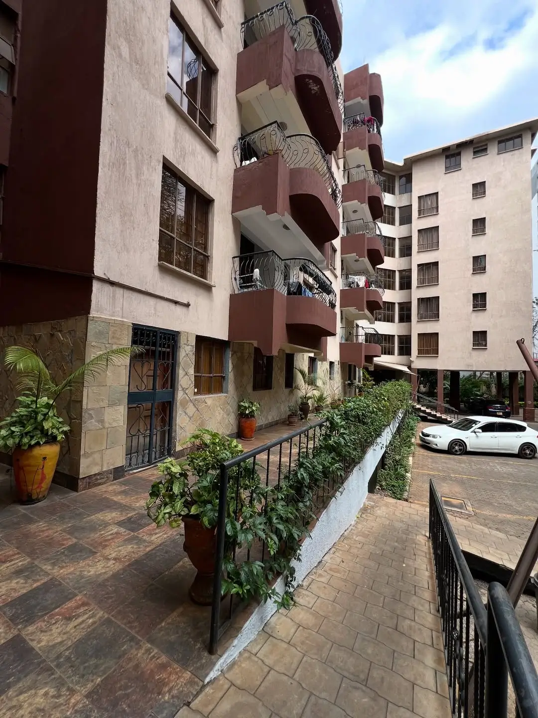Modern residential building compound with parking area and landscaping