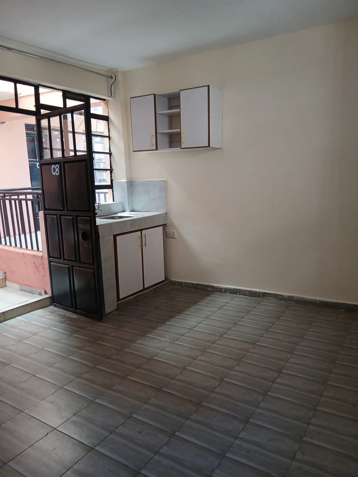 Compact kitchen with wall-mounted cabinets and sink counter