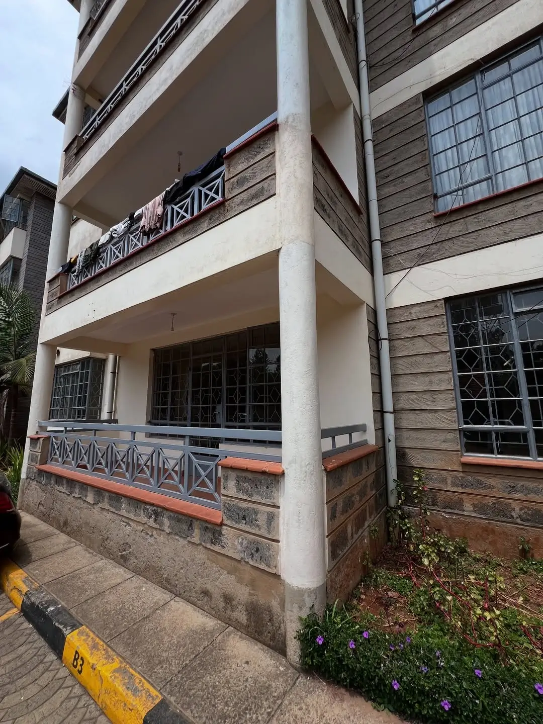 Multi-story residential building facade with balconies and entrance