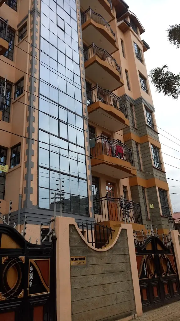Multi-story residential building facade with balconies and gate