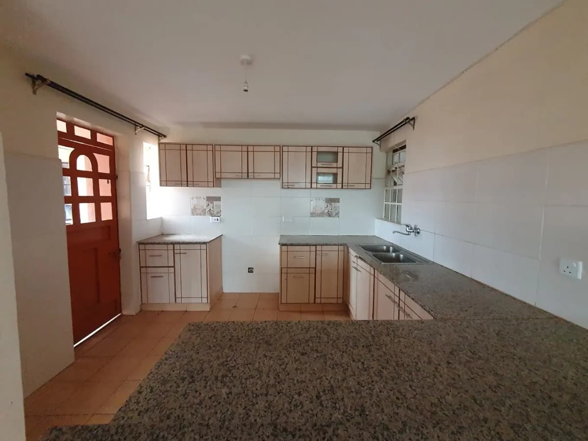 Spacious kitchen with wooden cabinetry and granite countertops