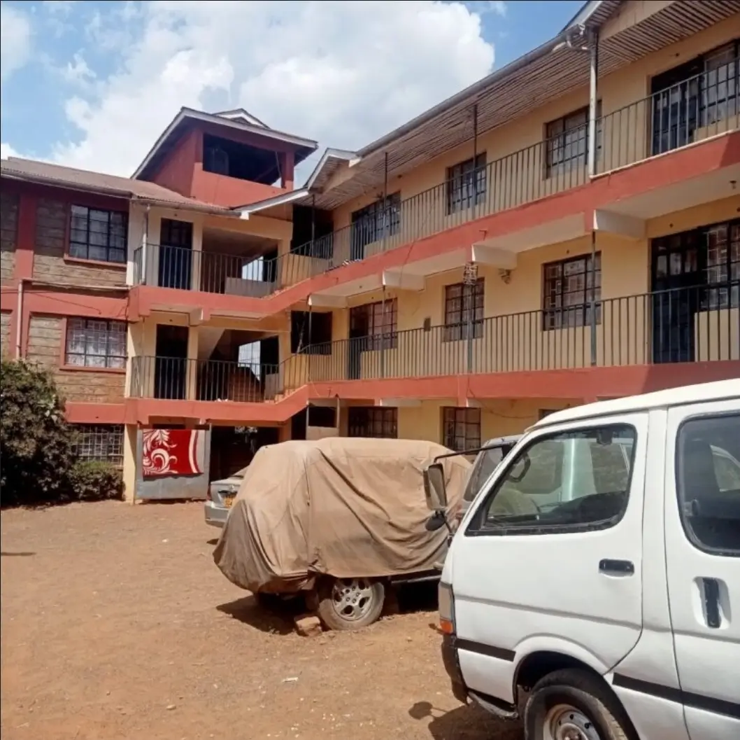 Multi-story residential building with covered parking compound