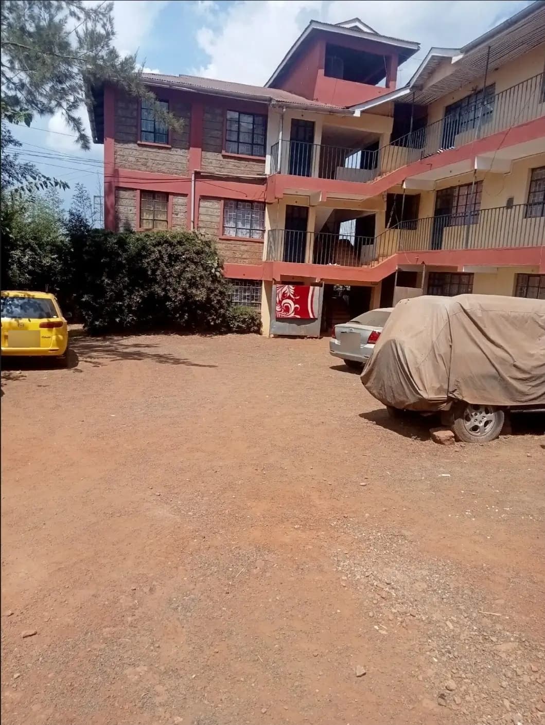 Multi-story residential building with compound parking area