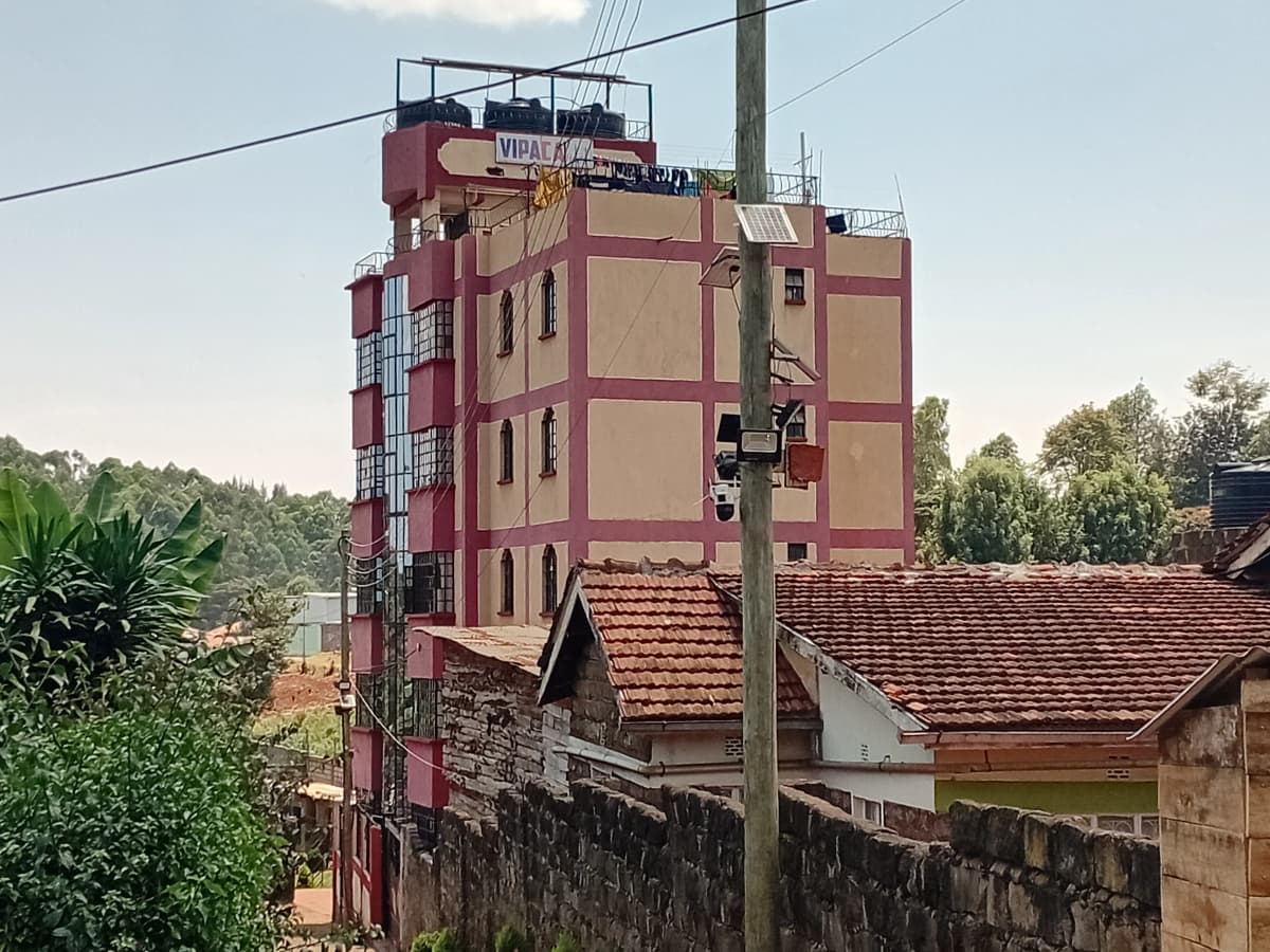 Multi-story residential building facade with red-tiled roof