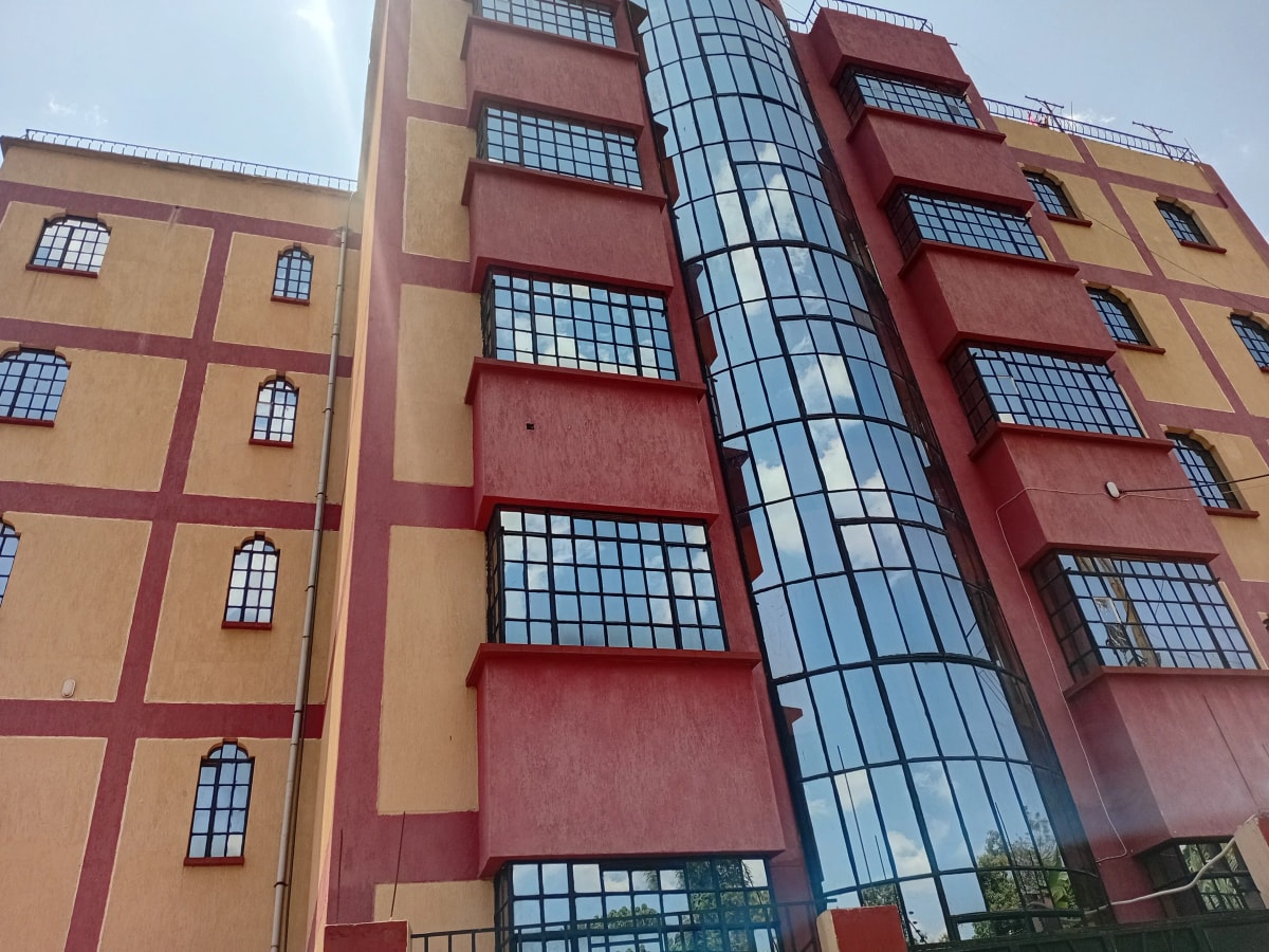 Multi-story residential building with red and yellow facade
