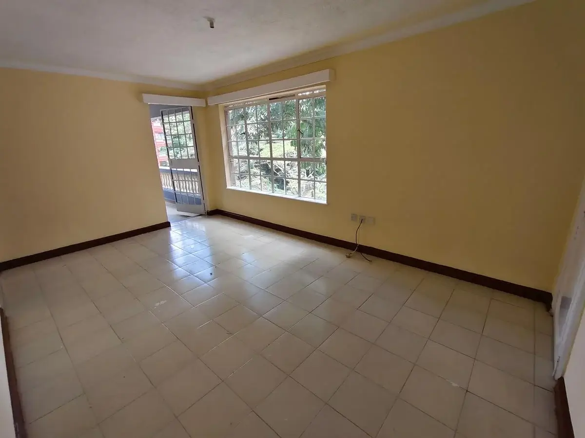 Spacious empty living room with tile flooring and natural light