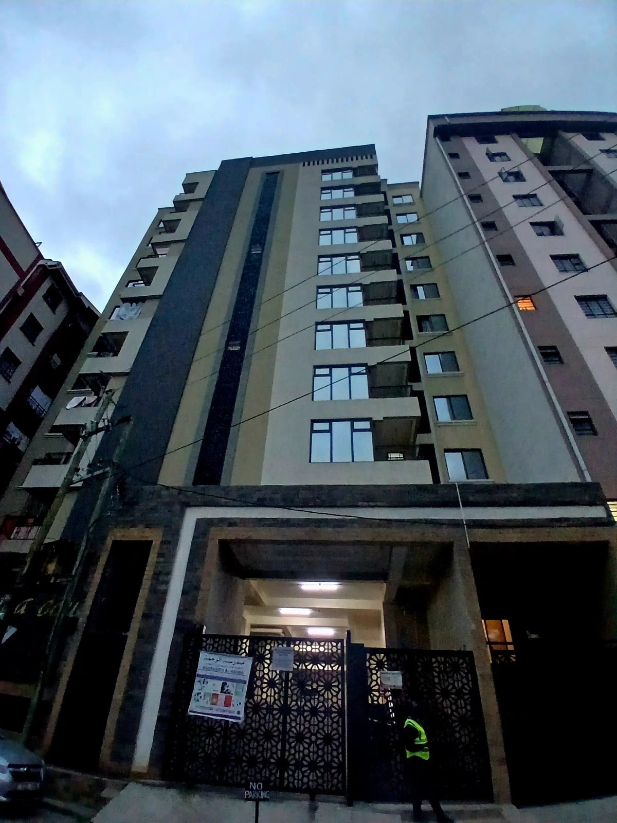 Modern multi-story residential building facade with ground-floor entrance