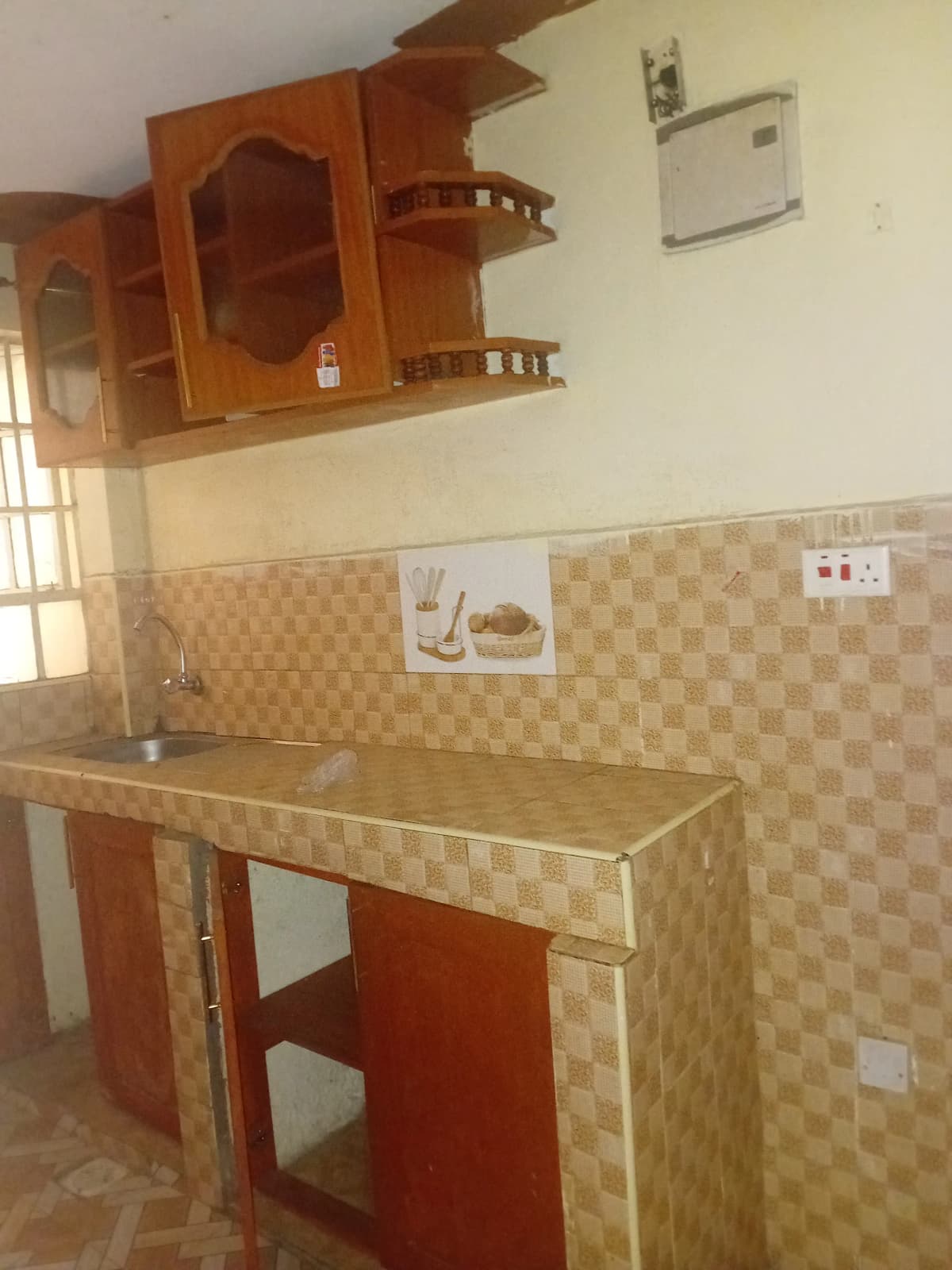 Compact kitchen with wooden cabinets and tiled backsplash