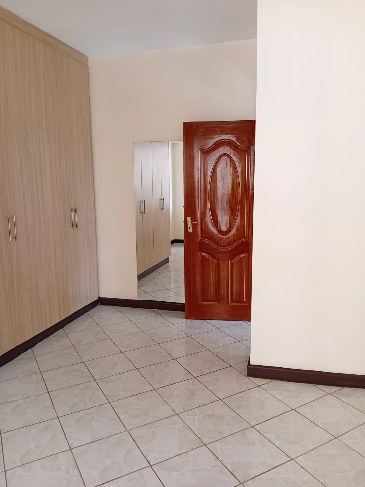 Bedroom entrance with wardrobe and red wooden door