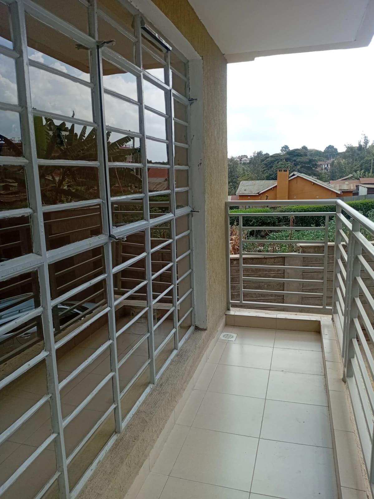 Spacious balcony with city views and metal railings
