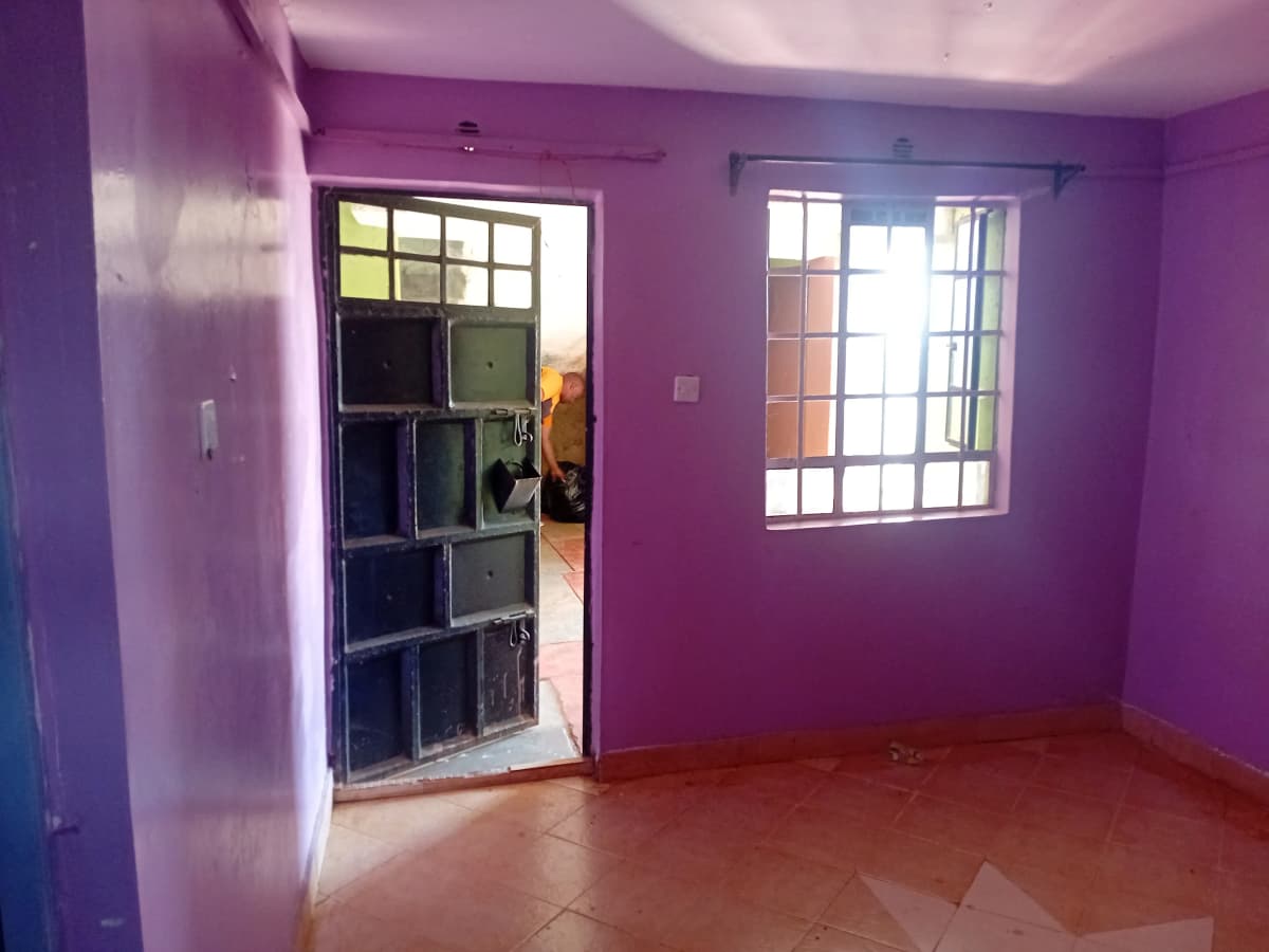 Bright purple bedroom with barred window and door access