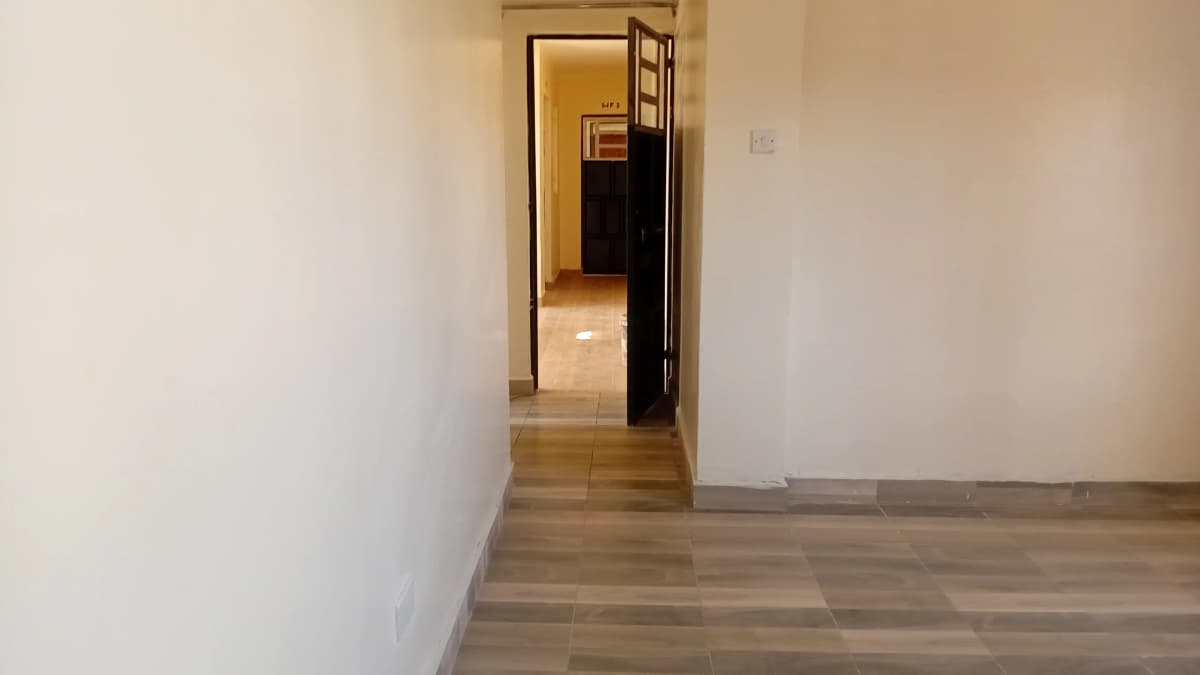 Bright corridor with wooden flooring and white walls