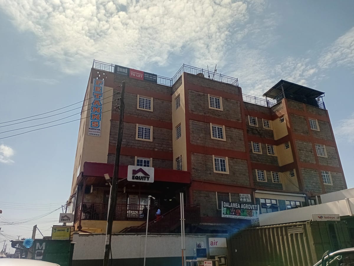 Multi-story residential building facade with ground floor shops