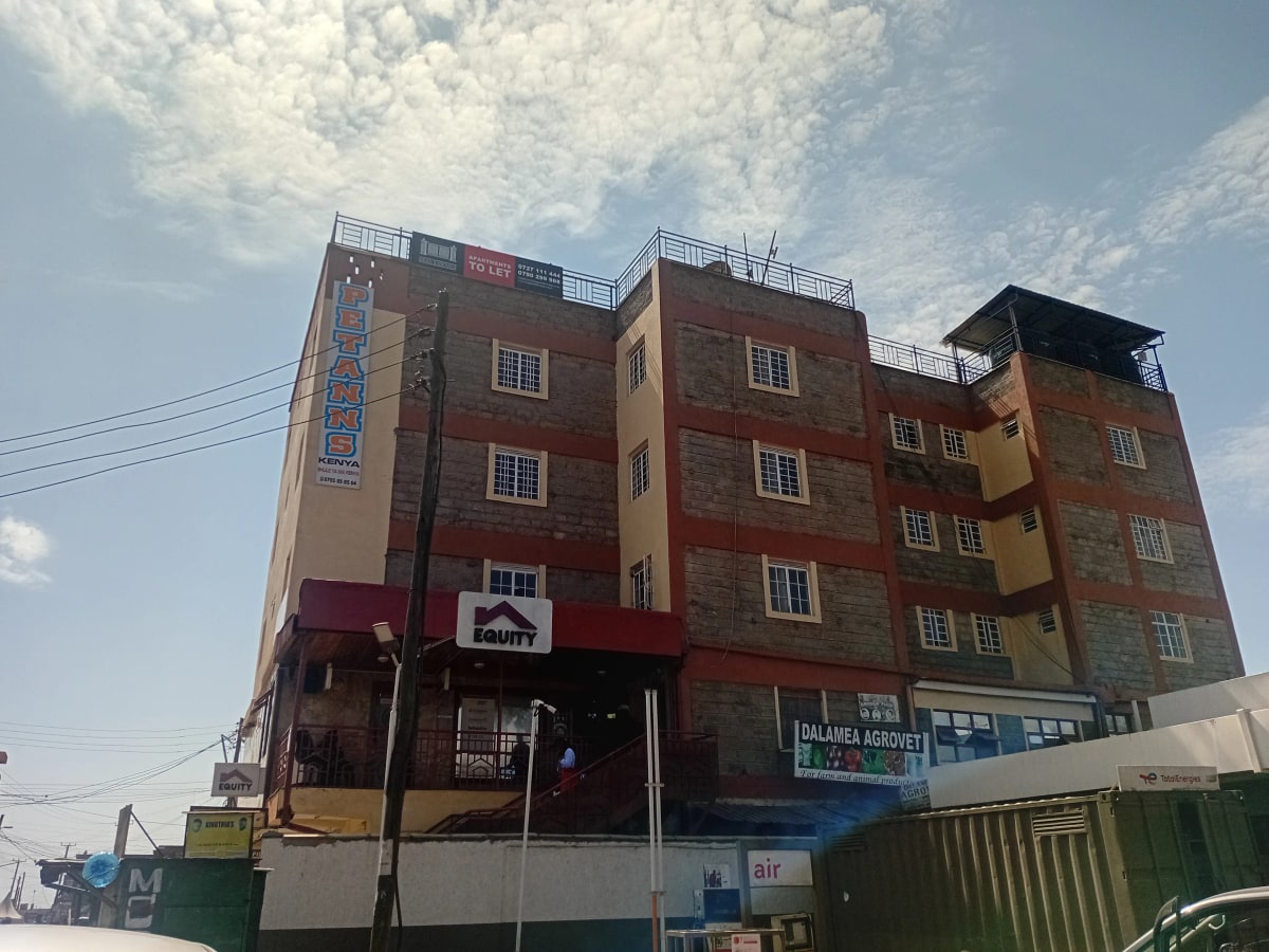 Multi-story residential building facade with ground floor shops