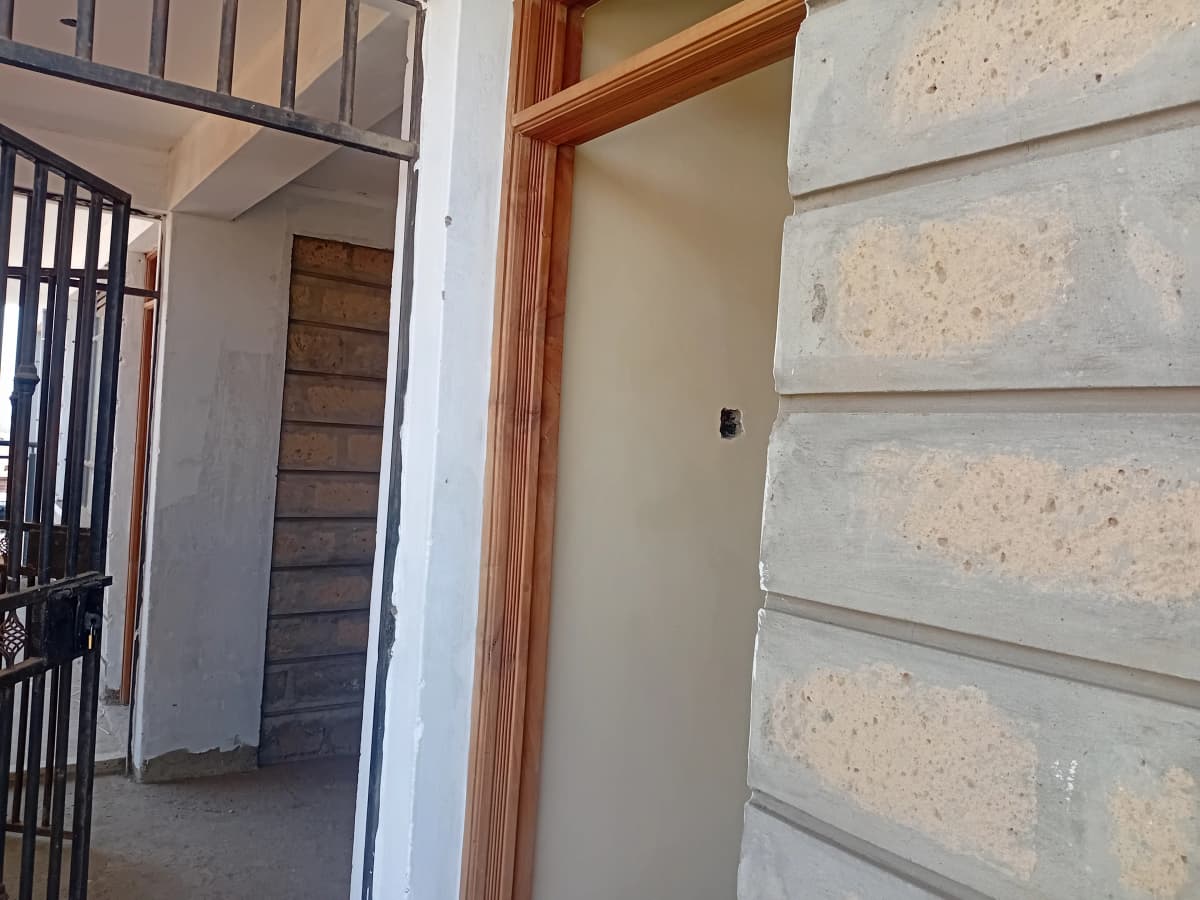 Building corridor with wooden frame doorway and concrete walls