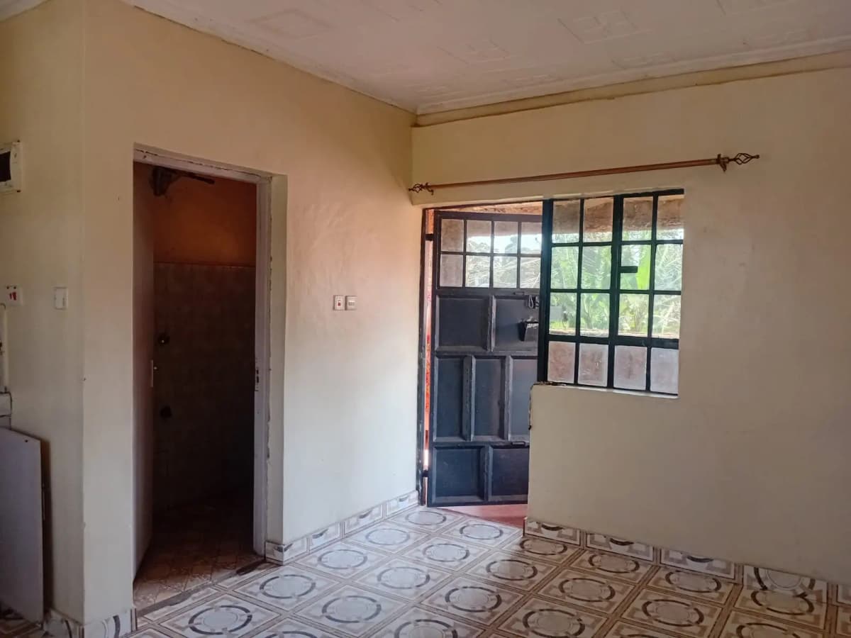 Simple bedroom with geometric floor tile and natural light
