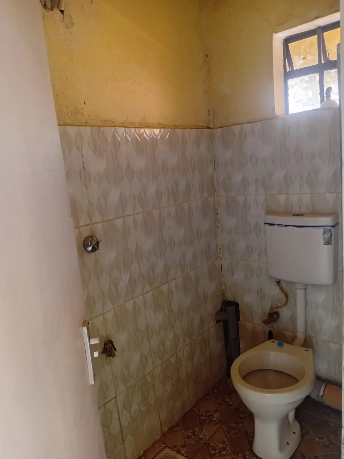 Basic bathroom with toilet, sink, and tiled shower enclosure