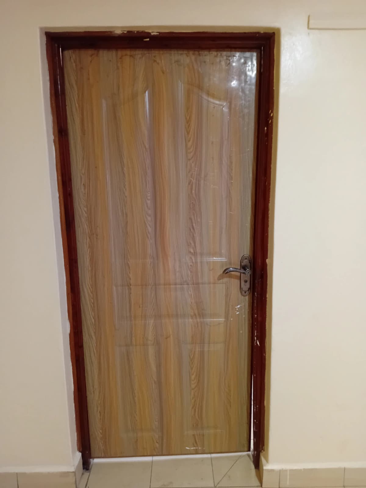 Wood-paneled door in neutral corridor or hallway