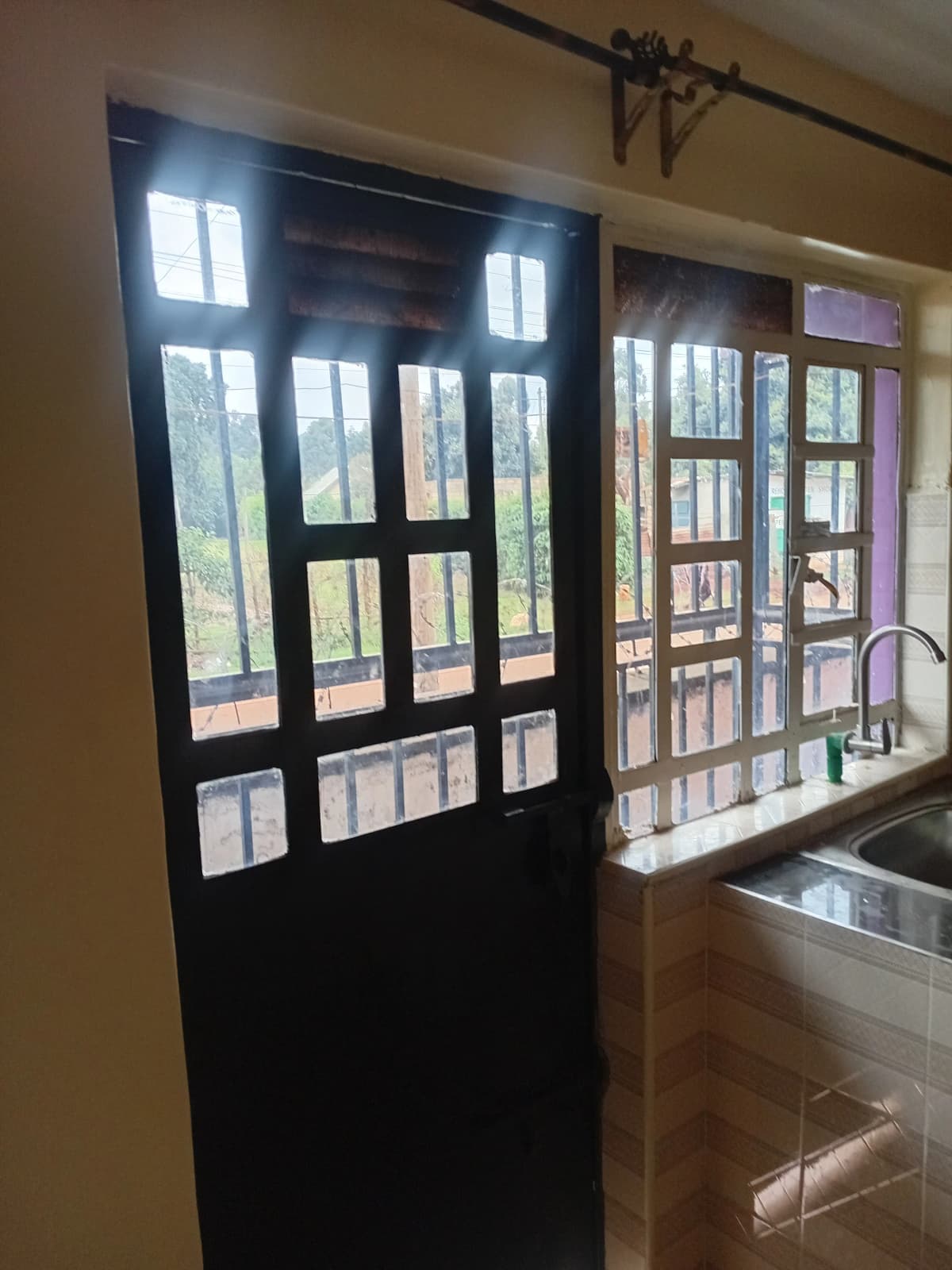 Kitchen with black-framed glass doors opening to balcony