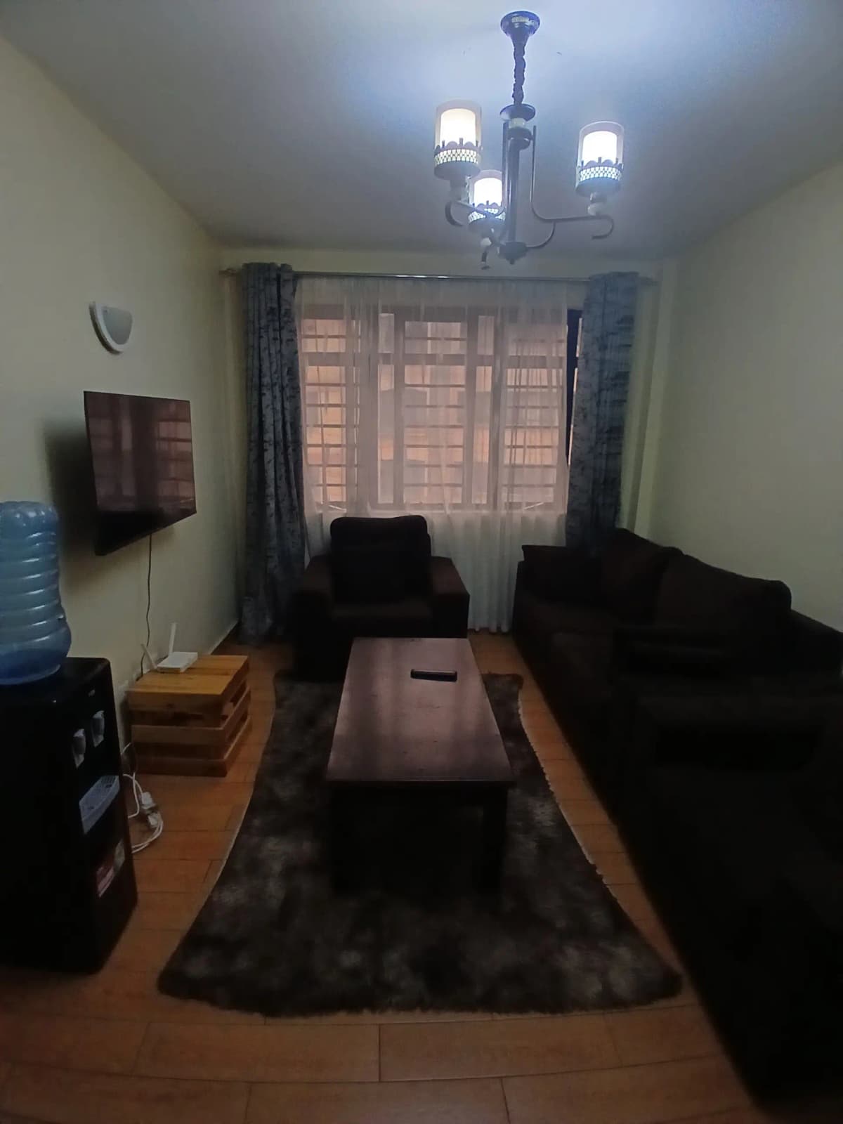Compact living room with black sofa and coffee table