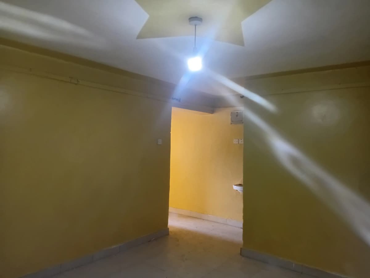 Empty hallway with yellow accent wall and ceiling light