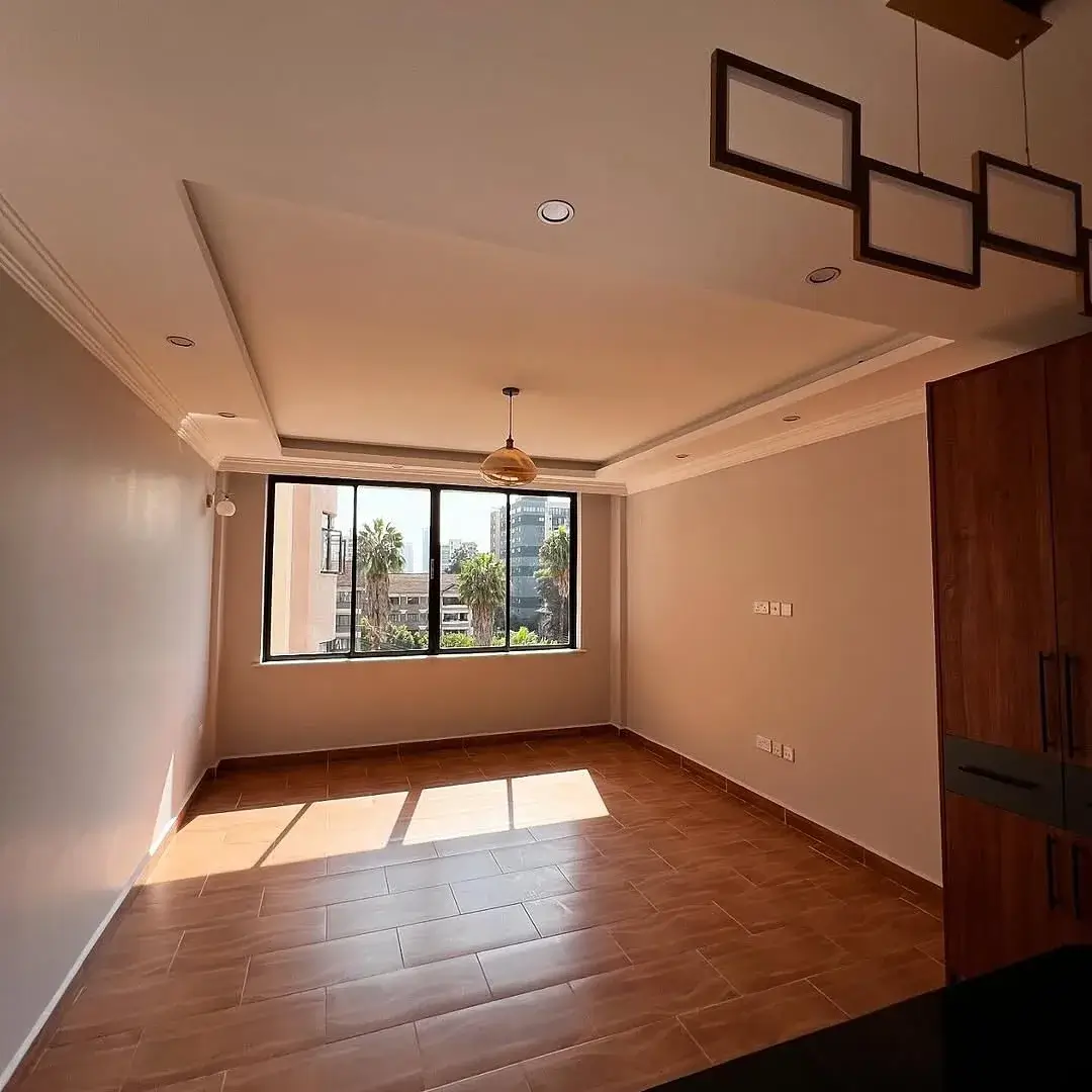 Bright living room with wooden floors and large windows