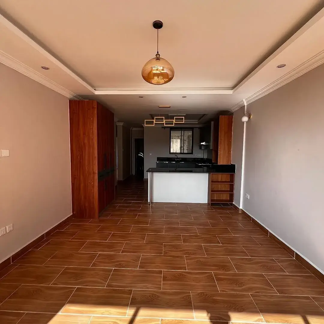 Open-plan living and kitchen area with terracotta tile flooring