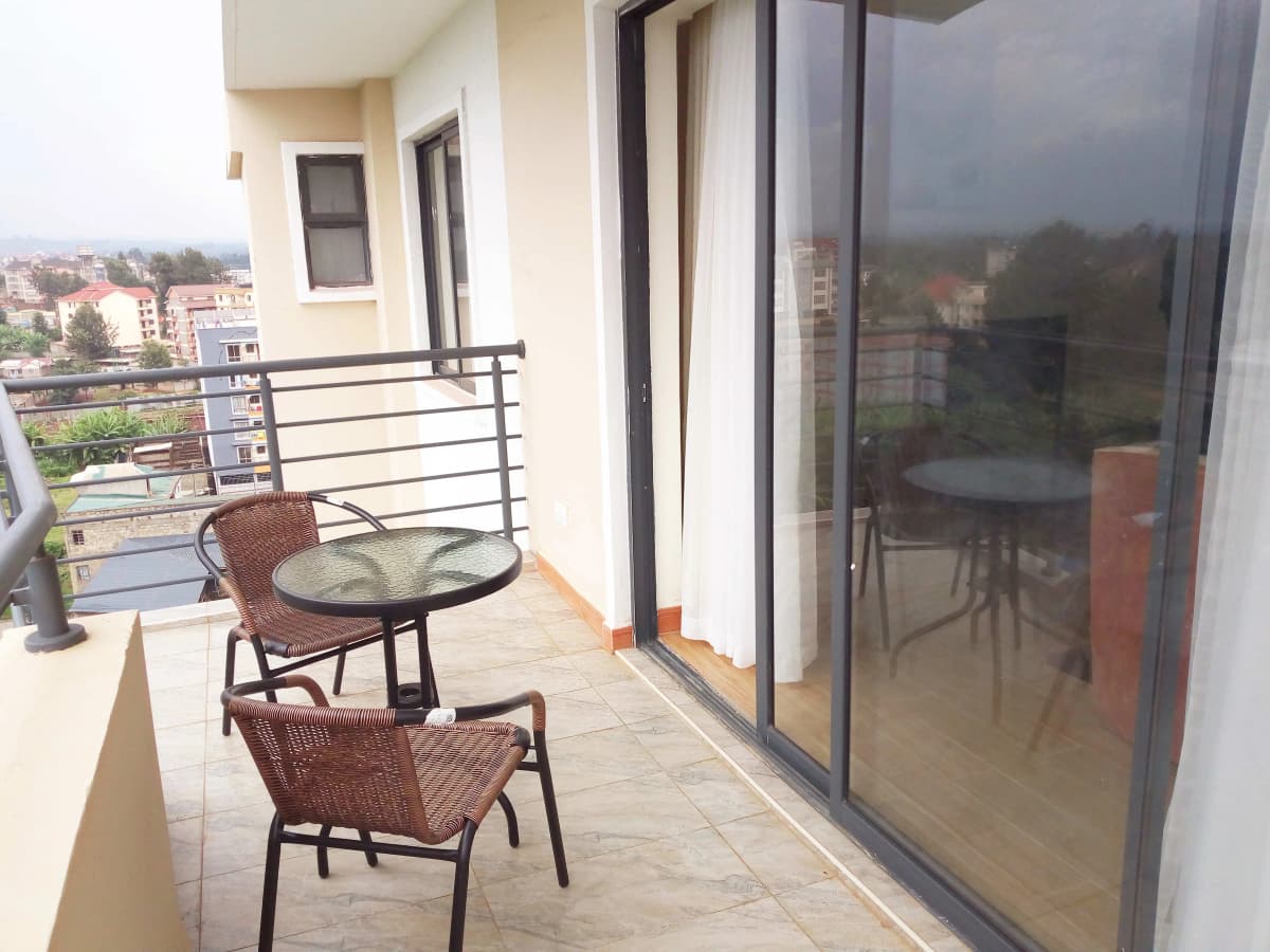 Spacious balcony with seating and city overlook