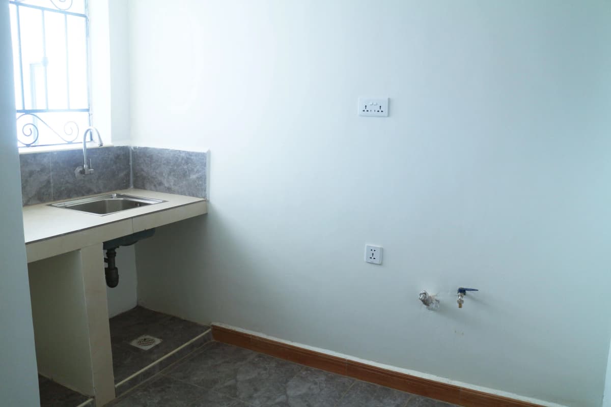 Compact kitchen with stainless steel sink and countertop
